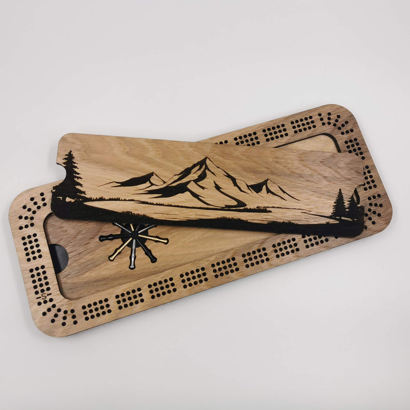 Mountain design engraved on a three-track cribbage board