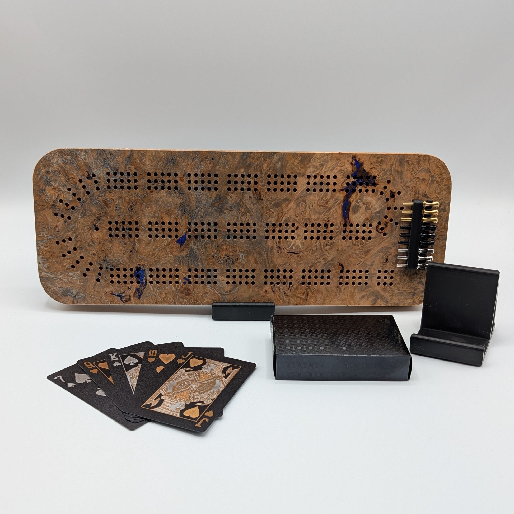 Cribbage board with pegs and cards on a white background