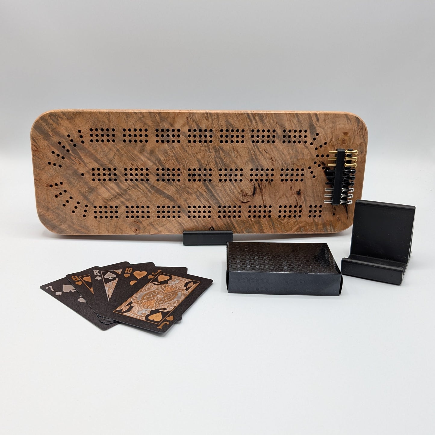 Wooden cribbage board with cards on a white background