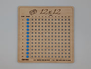 Single 12×12 engraved wooden board showing twelve numbered rows and blue markers in the start column