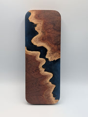 Reverse of the Australian red mallee burl and midnight blue epoxy Origin cribbage board, showing the flowing burl edge.