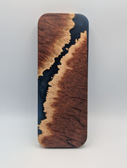 Reverse of the Australian red mallee burl cribbage board with a diagonal midnight blue epoxy channel and figured grain.