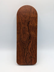 Reverse of the exact Caribbean rosewood cribbage board showing warm reddish brown wood and dark flowing grain