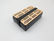 Acorn maple cribbage set packed with playing cards and a black retaining band